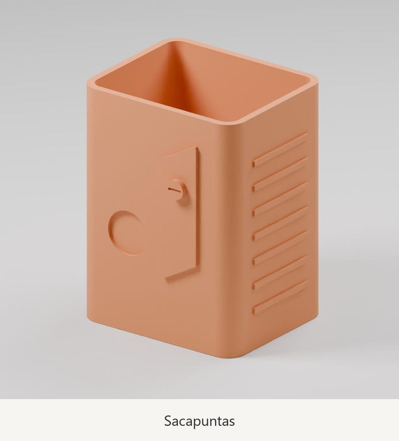 May include: A peach-colored pencil sharpener with a rectangular shape, featuring a small door-like detail with a circular knob and a series of horizontal raised lines on the side. The word Sacapuntas is printed below the object.