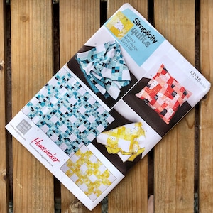 May include: Simplicity Quilts pattern K1330 for a wonky nine-patch quilting project. The pattern shows four different quilt designs in blue, yellow, and red color schemes.