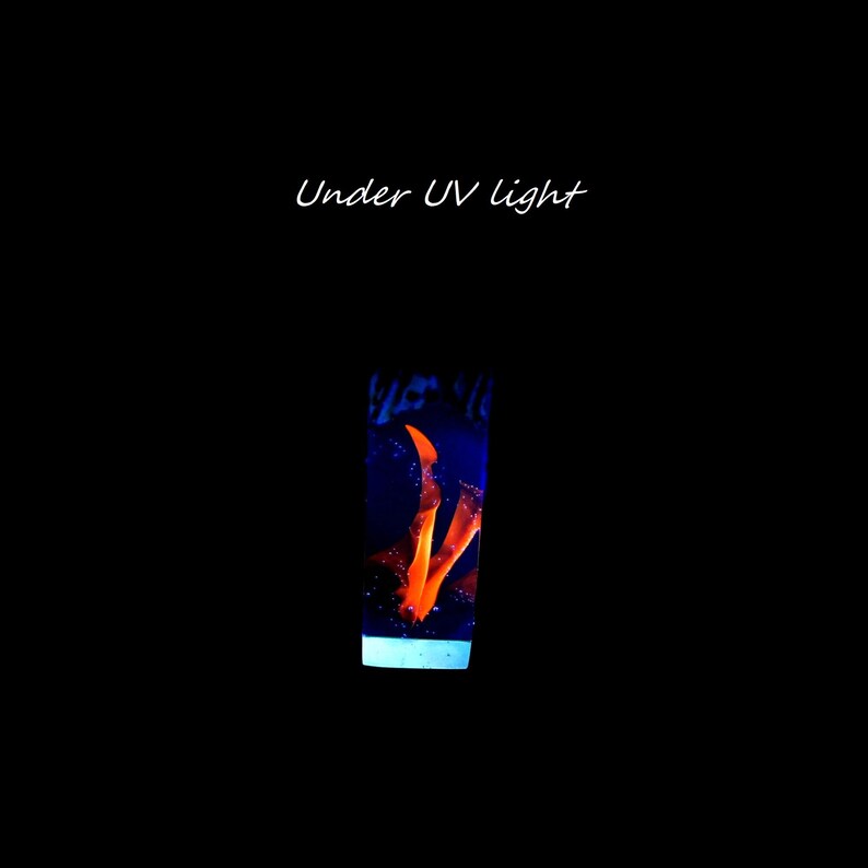 May include: A clear glass bottle with a blue and orange liquid inside. The liquid glows under a UV light. "Under UV light" is written in white text above the bottle.