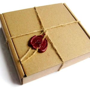 May include: A brown cardboard box tied with twine and sealed with a red wax stamp.