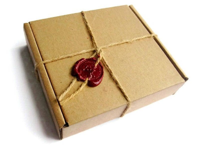 May include: A brown cardboard box tied with twine and sealed with a red wax stamp.