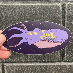 May include: A purple and yellow space creature with a large mouth and a single eye. The creature is swimming in a dark blue space with white stars.
