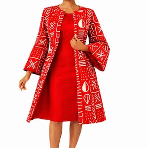 May include: A red dress paired with a matching open-front jacket. The jacket features a white geometric pattern. The outfit is completed with red heels. The overall style is elegant and suitable for various occasions.