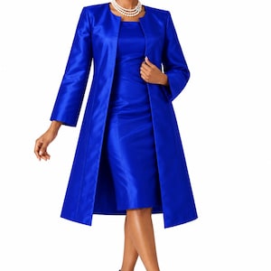 May include: A vibrant royal blue knee-length sheath dress paired with a matching long-sleeved open coat. The ensemble features a smooth, satin-like finish, a simple round neckline, and a structured silhouette. The outfit is completed with blue heels.