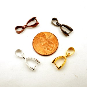 May include: Four pendant bails in different finishes: silver, gold, copper, and black. The bails are shown next to a US penny for size comparison.