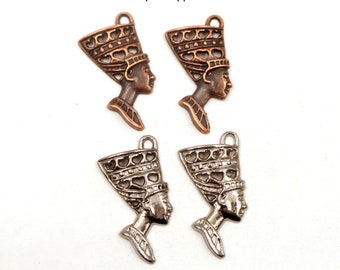 May include: Four metal charms in antique copper and gunmetal finishes. Each charm features a profile of a woman wearing a headdress. The antique copper charms are a warm brown color, while the gunmetal charms are silver.