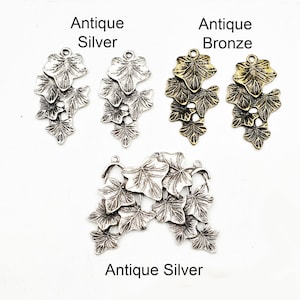 May include: Three antique silver ivy leaf charms and one larger antique silver ivy leaf charm with multiple leaves. The charms are perfect for jewelry making or crafting.