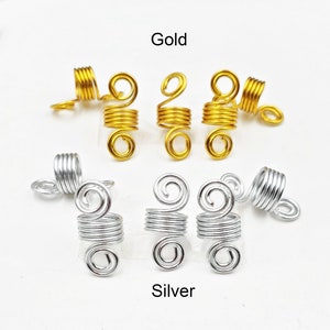 May include: Six gold and six silver hair coils. The coils are made of metal and are designed to hold hair in place. The coils are arranged in two rows, with the gold coils on top and the silver coils on the bottom.