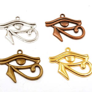 May include: Four silver, gold, and bronze charms in the shape of the Eye of Horus, an ancient Egyptian symbol of protection and good health.