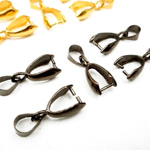 May include: A set of gold and gunmetal pendant clasps. The clasps are designed to hold a pendant or charm.