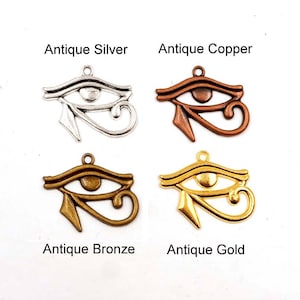 May include: Four antique silver, copper, bronze, and gold charms in the shape of the Eye of Horus, an ancient Egyptian symbol.