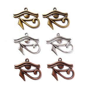 May include: Six metal charms in the shape of the Eye of Horus. Two are gold, two are silver, and two are copper.