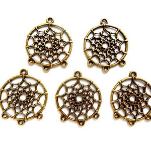 May include: Six antique gold-toned metal dreamcatcher charms with intricate designs. Each charm is circular with a web-like pattern and three loops for attaching to jewellery or other crafts.