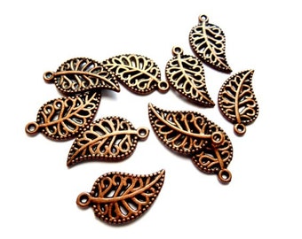 May include: Ten copper-colored metal leaf charms with intricate cut-out designs. Each charm has a small loop at the top for attaching to jewelry or other crafts.