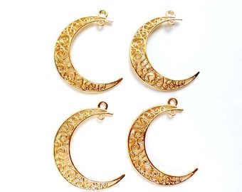 May include: Four gold-coloured metal crescent moon charms with intricate filigree designs. Each charm has a loop at the top for attaching to jewellery or other crafts.