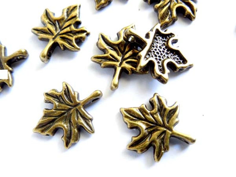 10 Antique Bronze Maple Leaf Charms 21-47-4 image 1