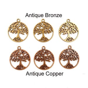 May include: Six metal charms in the shape of a tree of life. Three charms are antique bronze and three charms are antique copper.
