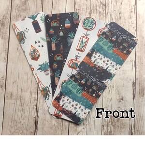 May include: Four different bookmark designs featuring a variety of potted plants in geometric shapes. The bookmarks are printed on a white background with black, green, orange, and brown accents. The word "Front" is printed in black at the bottom of the image.