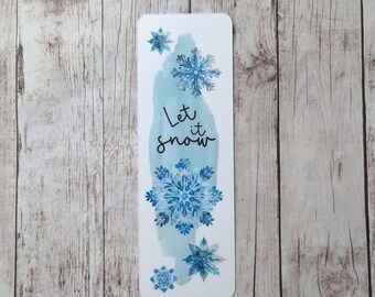 May include: A white bookmark with a watercolor design of snowflakes and the text "Let it snow".