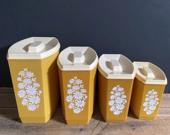 Set of Four Unmarked Lustro Ware (?) Mustard Yellow Gold White Floral Plastic Rectangular Nesting Kitchen Canisters - One Has CRACKED