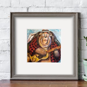 May include: A framed painting of a cartoon bear wearing a hat and plaid shirt, playing a guitar. The bear has a surprised expression on its face. The guitar has the words "Big Al" written on it.