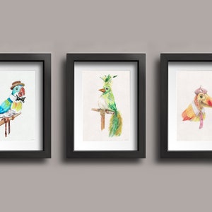 May include: Three framed watercolor paintings of birds wearing hats and bowties. The first bird is blue, green, and yellow with a brown hat and a black bowtie. The second bird is green with a green and yellow crown and a brown branch. The third bird is orange and yellow with a brown hat and a pink bowtie.