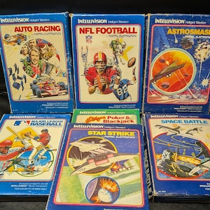 May include: A collection of vintage Intellivision video game cartridges. The boxes feature colorful graphics for games like "Auto Racing," "NFL Football," "Astrosmash," "Major League Baseball," "Star Strike," and "Space Battle."