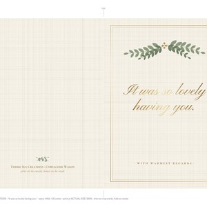 May include: A folded greeting card with a cream-colored grid background. The front features a green leaf sprig, gold-toned text reading 'It was so lovely having you.', and the phrase 'WITH WARMEST REGARDS' enclosed in a thin gold border.