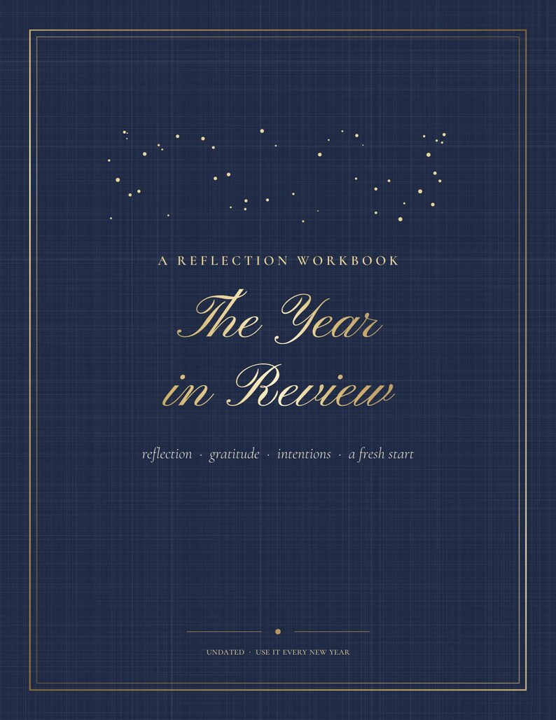 May include: A dark blue reflection workbook titled The Year in Review with gold text and a constellation graphic. The cover features the words A REFLECTION WORKBOOK, reflection, gratitude, intentions, a fresh start, and UNDATED USE IT EVERY NEW YEAR.