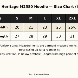 May include: A Cotton Heritage M2580 hoodie size chart in inches. The table lists chest width and body length for sizes S through 3XL. It includes notes on unisex sizing, garment measurements, and how to measure chest width and body length.