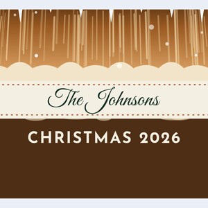 May include: A rectangular sign featuring a brown background with a stylized white snowy landscape and vertical brown lines. A central cream-colored banner with stitched edges displays the text The Johnsons and CHRISTMAS 2026.