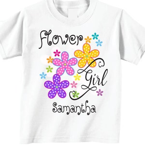 May include: White t-shirt with a colorful flower design and the text "Flower Girl Samantha".