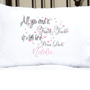 May include: White pillow with a pink and gray star design and the text "All you need is Faith, Trust & a little bit of Pixie Dust Natalie".