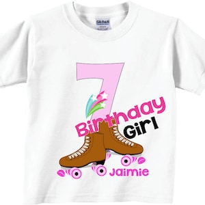 May include: White t-shirt with a pink number 7, the words "Birthday Girl" and a pair of brown roller skates. The text "Jaimie" is below the skates.