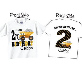 May include: White t-shirt with a yellow dump truck graphic carrying gray rocks. The front says "IT'S MY 2nd BIRTHDAY Caiden". The back says "CAN YOU DIG IT? I AM..." with a number 2 and a dump truck graphic.