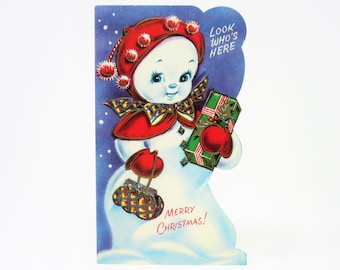 Vintage Unused Christmas Greeting Card Features Snow-girl with Red Hat and Mittens Holding a Purse and a Gift Wrapped Package Holly Berries