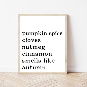 May include: Black and white typography print with the text "pumpkin spice cloves nutmeg cinnamon smells like autumn".