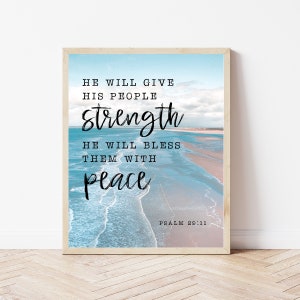 May include: A framed print with a blue and white ocean background. The text reads "He will give his people strength. He will bless them with peace. Psalm 29:11"