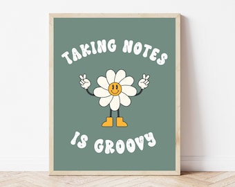 May include: A green framed print with a white daisy with a smiley face and peace signs. The text "Taking Notes Is Groovy" is written in white with a vintage font.