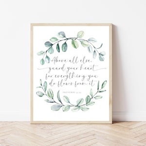 May include: A white printable wall art print with a green watercolor wreath and the text "Above all else, guard your heart for everything you do flows from it. Proverbs 4:23"