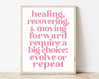 May include: Pink motivational quote print in a wooden frame. The quote reads "healing, recovering, & moving forward require a big choice: evolve or repeat."