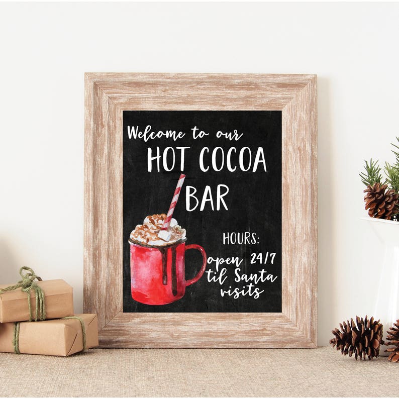 May include: A printable sign with a chalkboard background and a watercolor illustration of a red mug of hot cocoa with whipped cream and a candy cane straw. The sign says "Welcome to our Hot Cocoa Bar" and "Hours: open 24/7 til Santa visits".