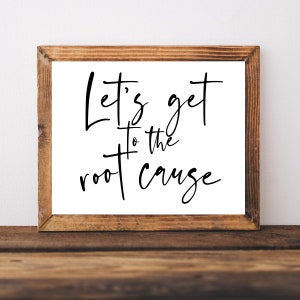 May include: A framed print with a white background and black calligraphy text that reads "Let's get to the root cause".