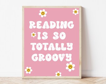 May include: Pink and white printable wall art with the text "Reading is so totally groovy" and daisy flowers with smiley faces.