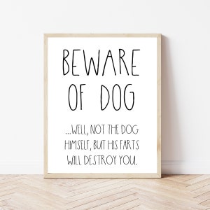 May include: A white framed sign with black text that reads "BEWARE OF DOG... WELL, NOT THE DOG HIMSELF, BUT HIS FARTS WILL DESTROY YOU."