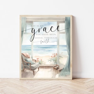 Peut inclure: Une peinture à l'aquarelle d'une scène de plage avec une fenêtre donnant sur l'océan. Le texte "Car c'est par la grâce que vous êtes sauvés, par la foi" est écrit sur la fenêtre. Le texte "Éphésiens 2:8" est écrit sous la citation.