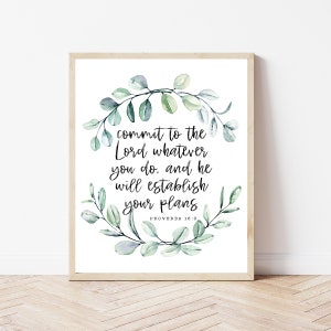 May include: A white printable art print with a watercolor wreath of green leaves and the text "commit to the Lord whatever you do. and he will establish your plans" with the scripture reference "PROVERBS 16:3".