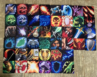 May include: A collection of forty-one square coasters featuring colorful fantasy illustrations of weapons, shields, skulls, magical spells, and character portraits arranged in a grid pattern on a light wooden surface.