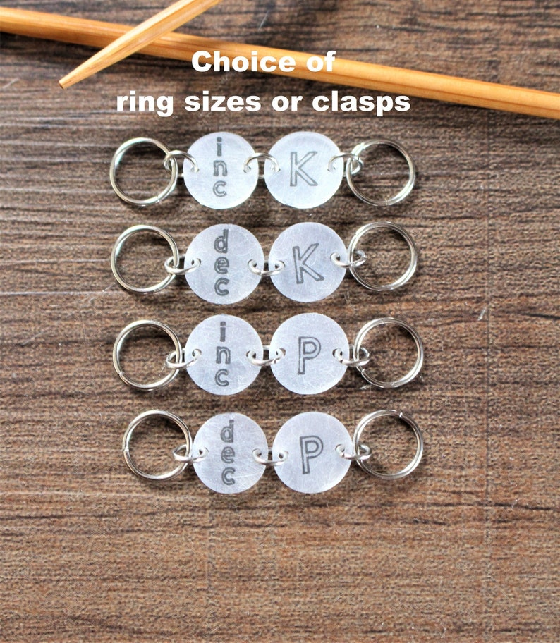 May include: Four sets of silver knitting stitch markers with clear plastic rings. Each set has two markers with the words "inc" or "dec" on one marker and "K" or "P" on the other marker.