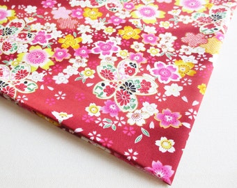 May include: Red fabric with a floral pattern featuring pink, white, and yellow flowers. The fabric has a traditional Japanese design.